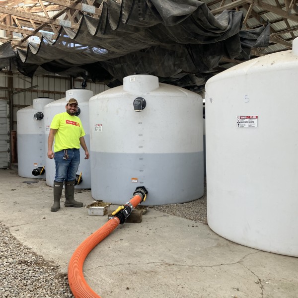 Man stands next to manure mesocosm