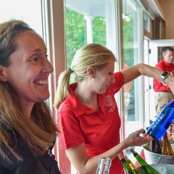 Lidsey serving wine at an event