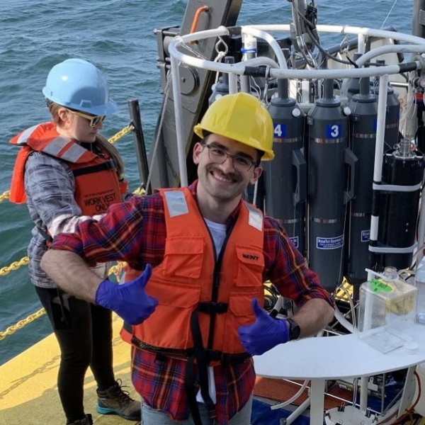 Researchers wearing protective gear work aboard the U.S. EPA’s Lake Guardian research vessel