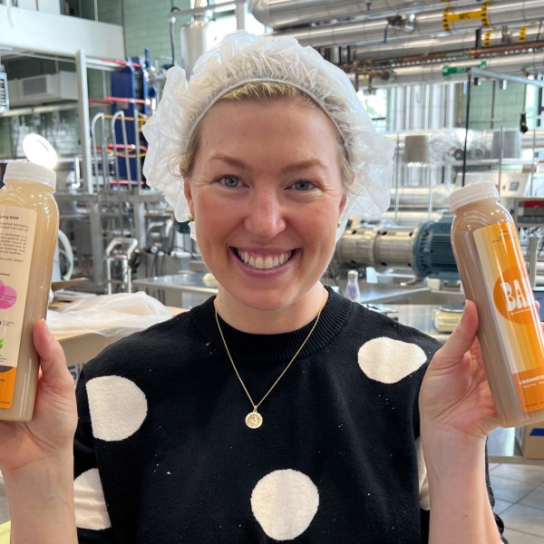 Paige Hansen holds products developed at the Cornell Food Venture Center.