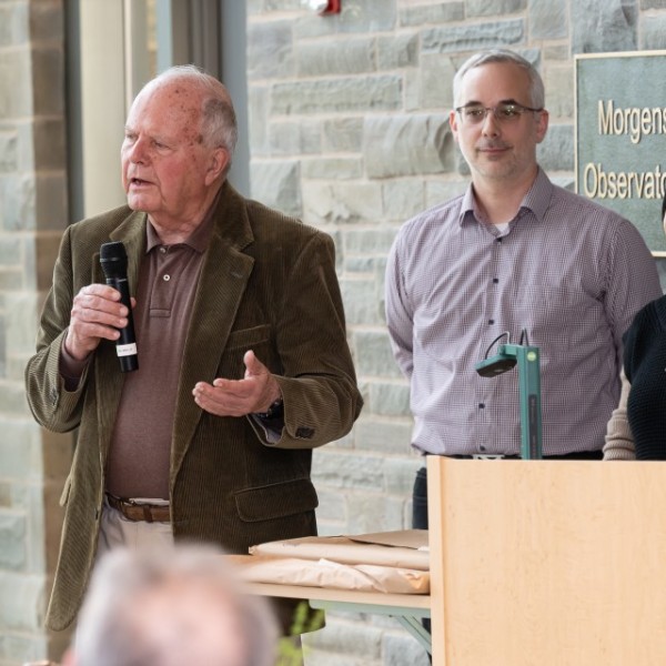 Three people address a crowd