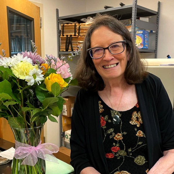 Margery Daughtrey in lab with bouquet