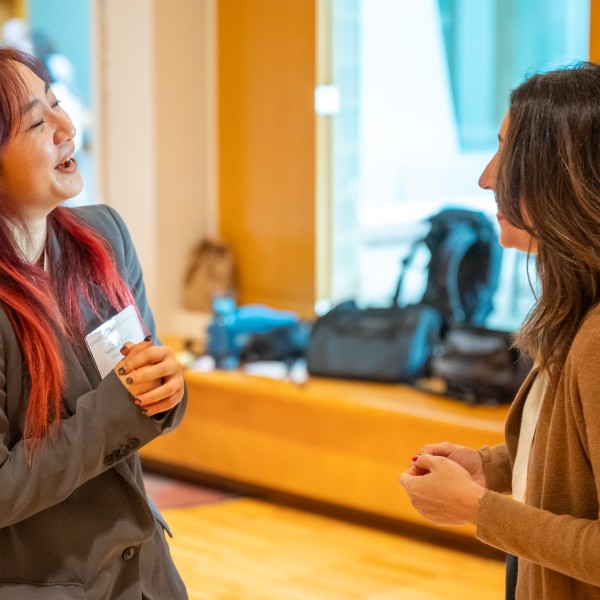 Sandria talking with someone about her project  at the 2025 CCE summer intern reception