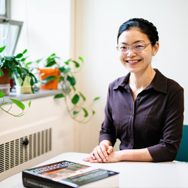 a woman sits at a table