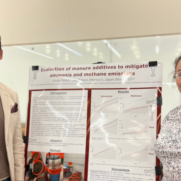 two people standing by a science poster