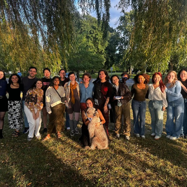 Comm Grad students gather for a photo in the a park