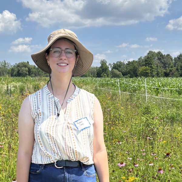 Rebecca Stup in front of a field