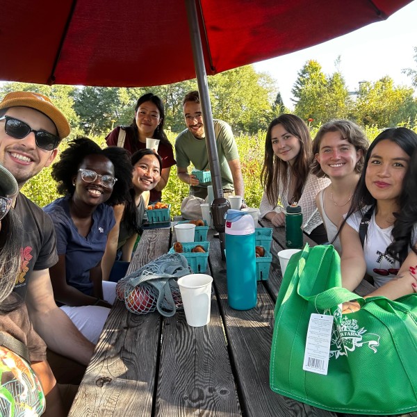 people sit around picnic table at farm