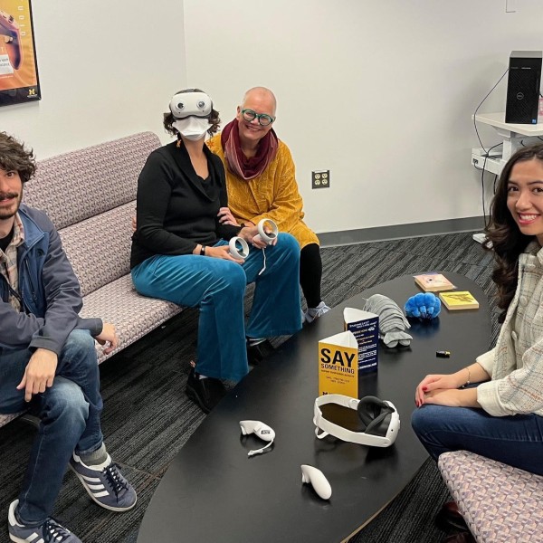 four individuals sit around a table
