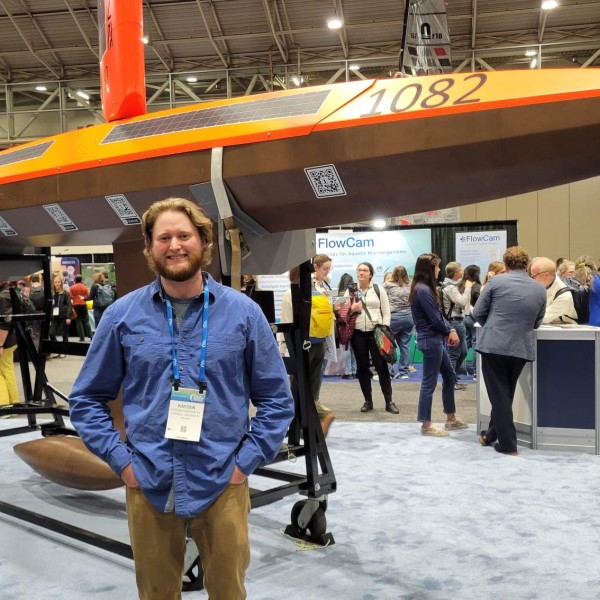 Person standing in front of a saildrone