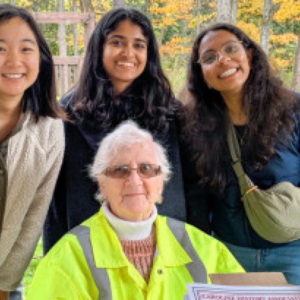 Students post with local volunteer