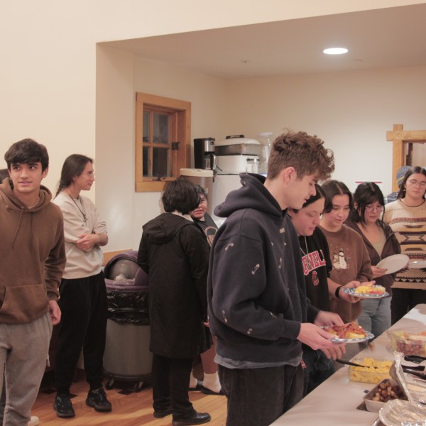 Students wait in line for a buffet.