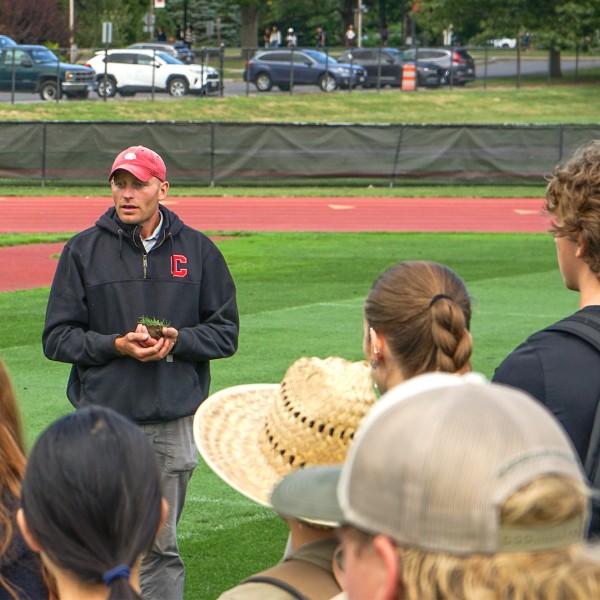 sitko talking to class on athletic field