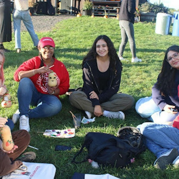 students sit in a circle in the grass