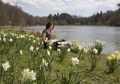 student reading by lake