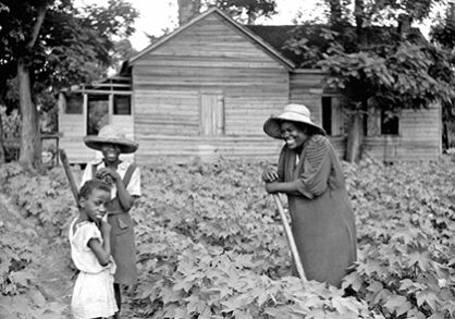 black and white image of people working in a garden