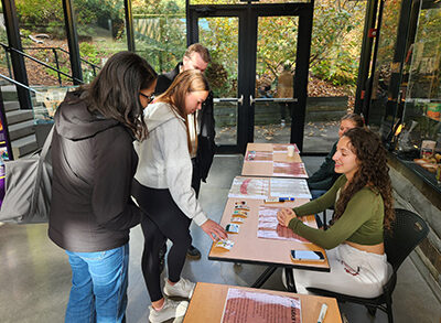 Student at table talking with visitors