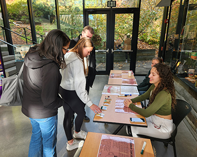 Student at table talking with visitors