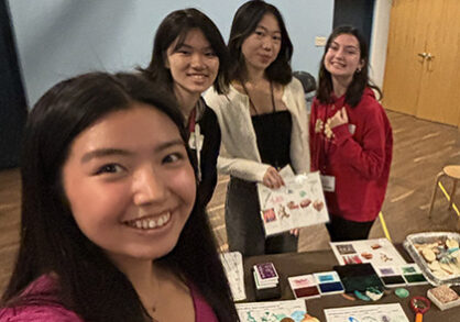 Students at a table sharing a nature project